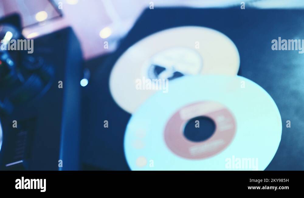 Vinyl record player. Slide the rotating plate, man's hand puts the