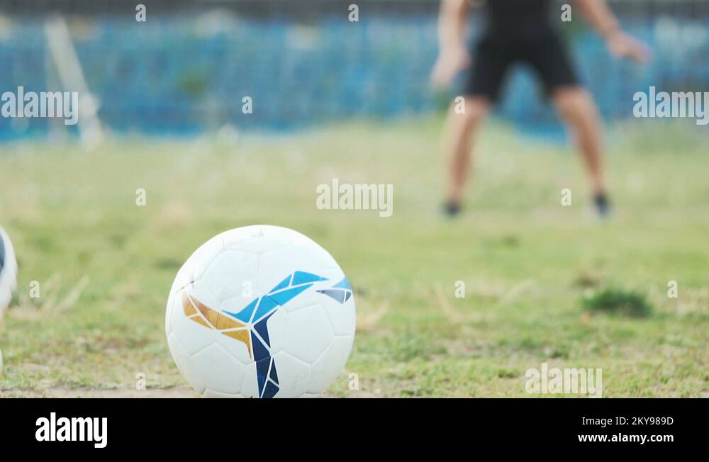 Slide slow motion football tricks, player kicked ball straight goalie's