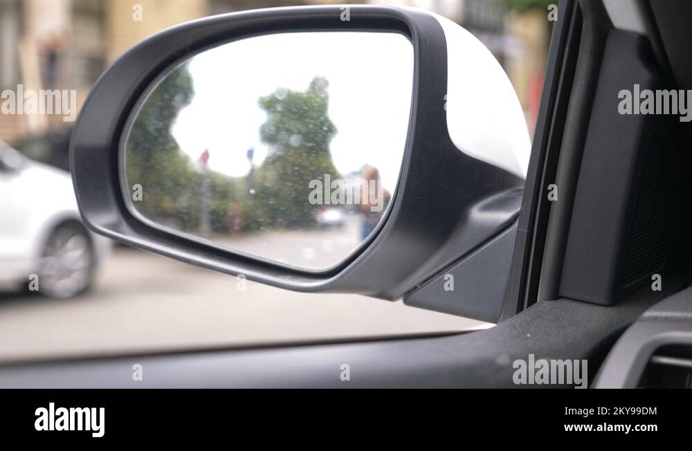 rear view mirror of the car with traces of rain. a blurry reflection in