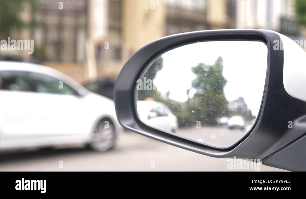 rear view mirror of the car with traces of rain. a blurry reflection in
