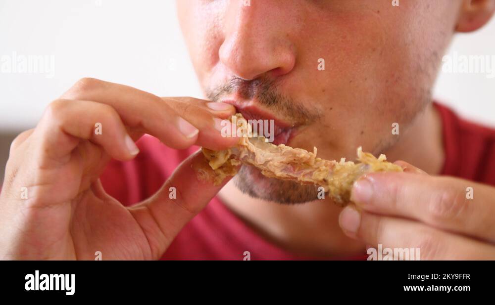 man eating fast food meat chicken wings unhealthy lifestyle bad diet