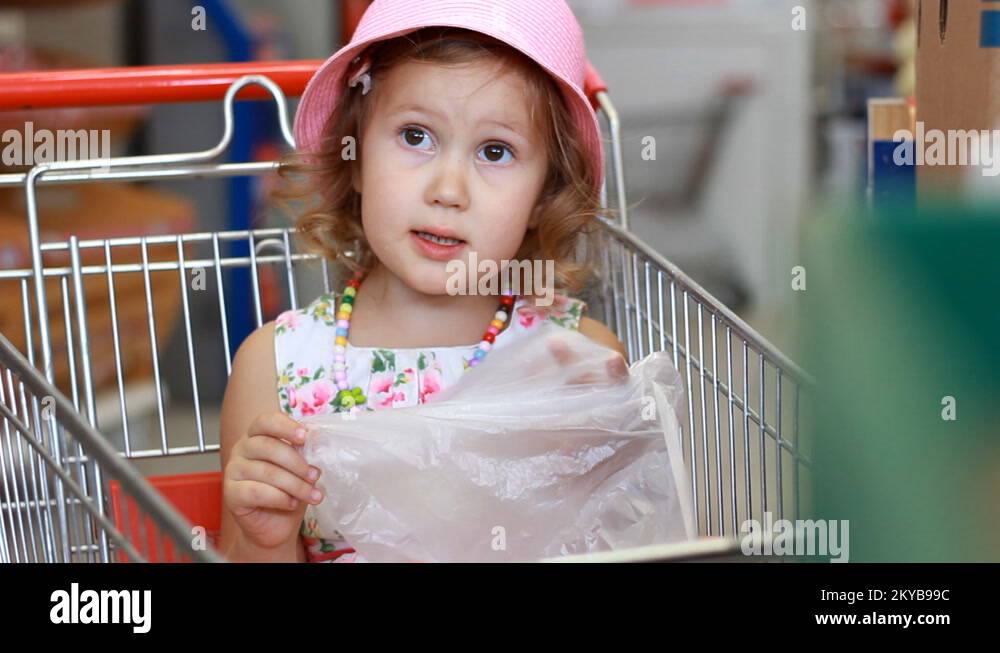 Child girl in the store chooses fruit. Grocery supermarket and shopping