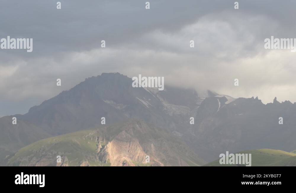 mountain top is shrouded in fog. a cluster of clouds in the sky Stock ...