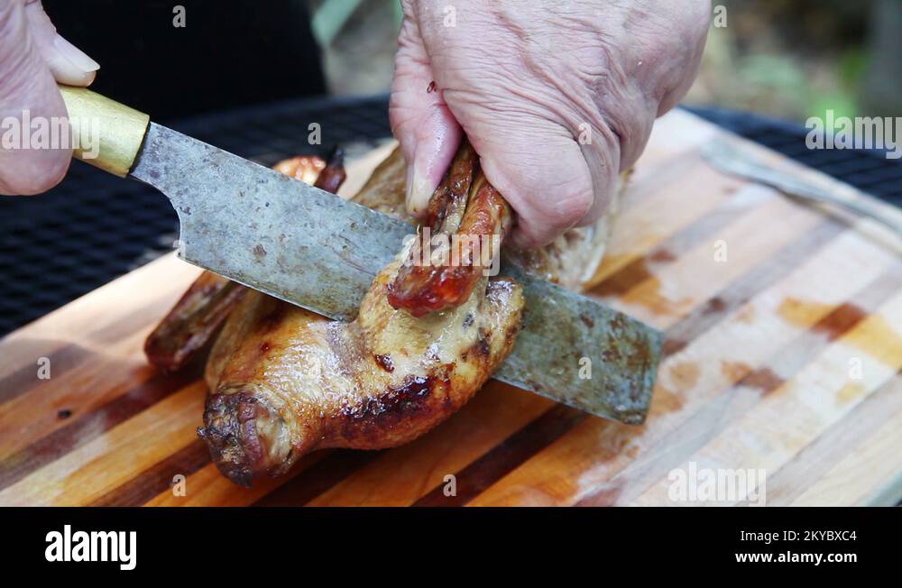 Cutting wings off roast duck Stock Video Footage Alamy
