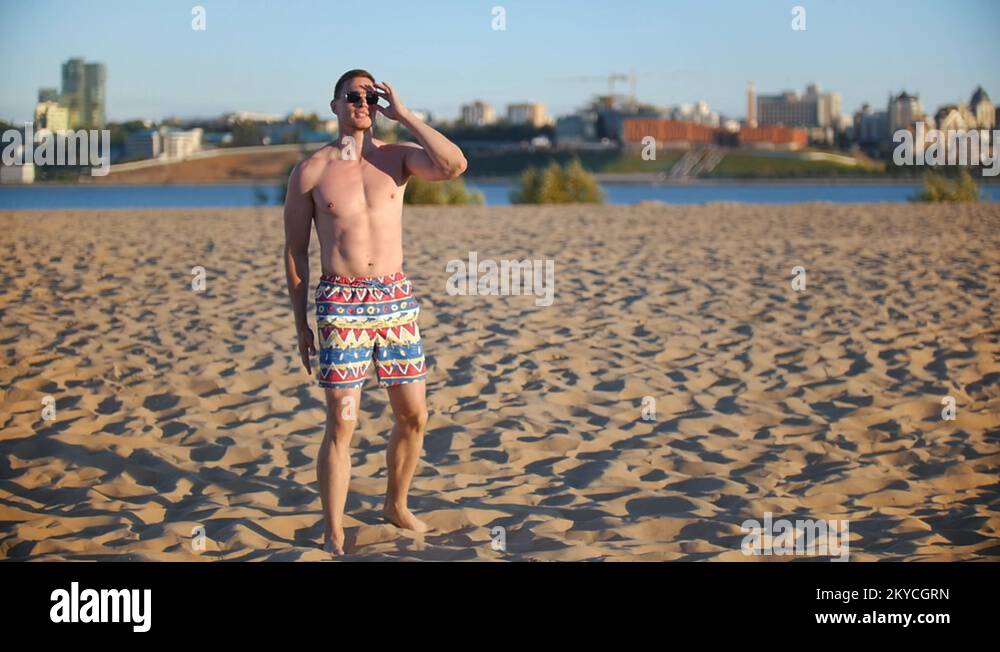 Athletic man with glasses playing beach volleyball, the glasses falling