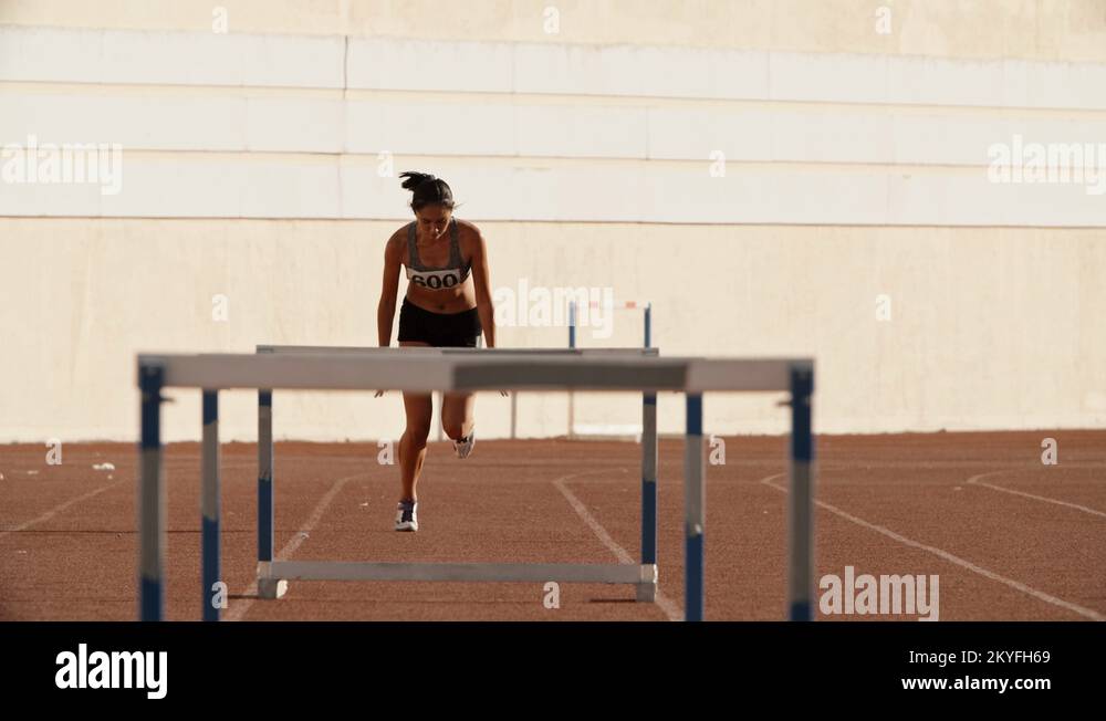 Female athlete on track. Young asian runner running on track of stadium