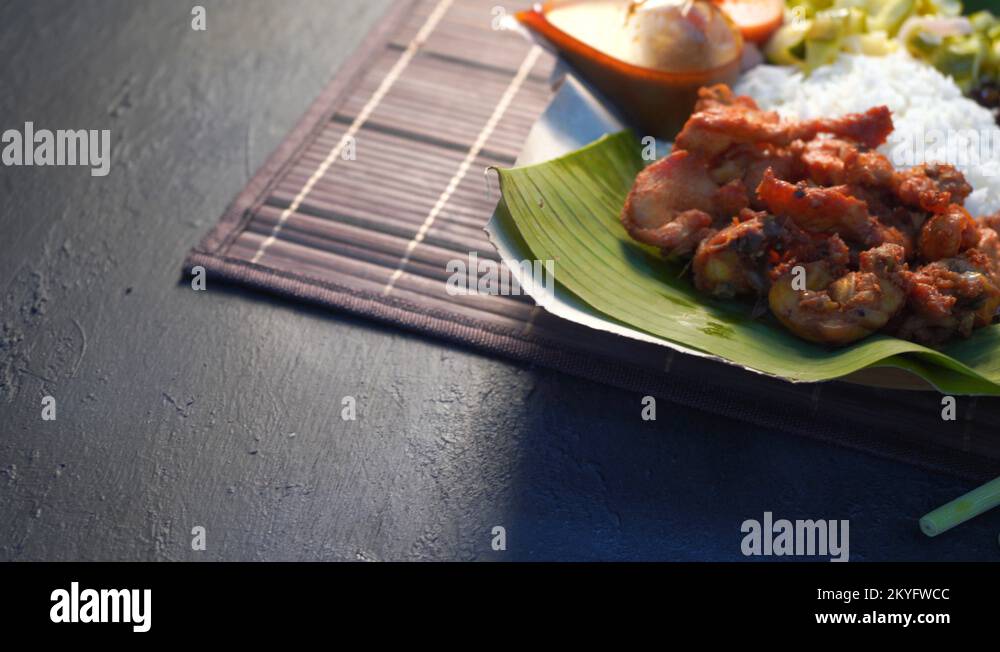 nasi kukus, traditional malay steamed rice with tumeric fried chickens