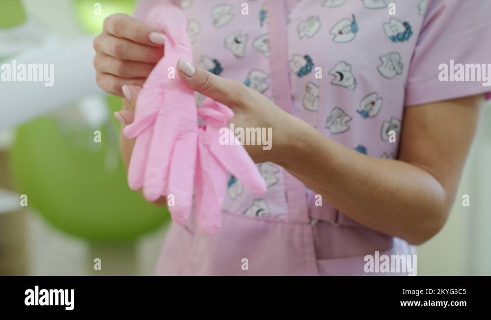 Female nurse putting on health gloves. Healthcare worker put on medical