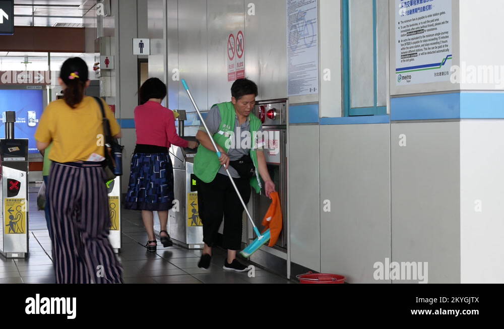 Motion of worker cleaning floor and wall inside MRT station with 4k