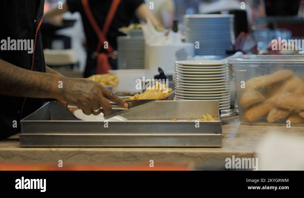 French fries in deep fryer, restaurant kitchen burger chef Stock Video