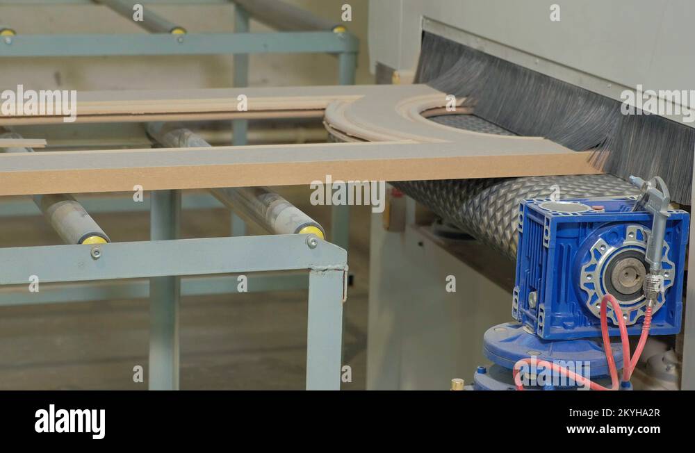 the process of grinding wooden doors on the machine.production of