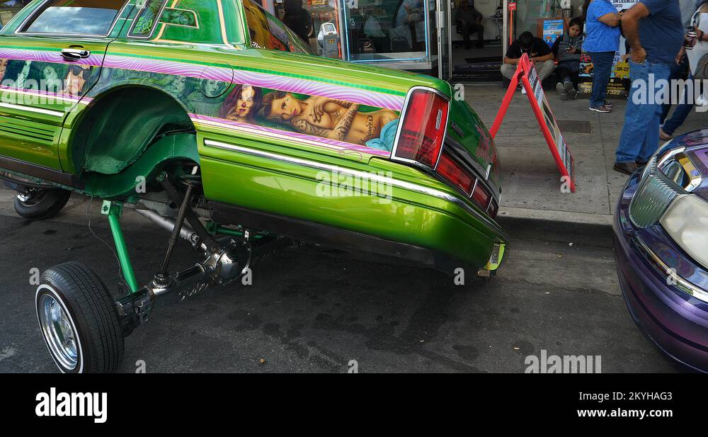People looking at hydraulic lowrider classic car suspensions in Los Angeles, 4K Stock Video