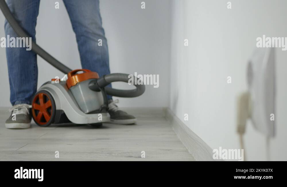 Employee Using a Vacuum Cleaner in Office Clean Dirty from Room Floor