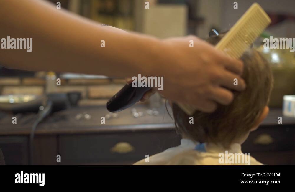 Cutting children hair with electric razor in Closeup kids