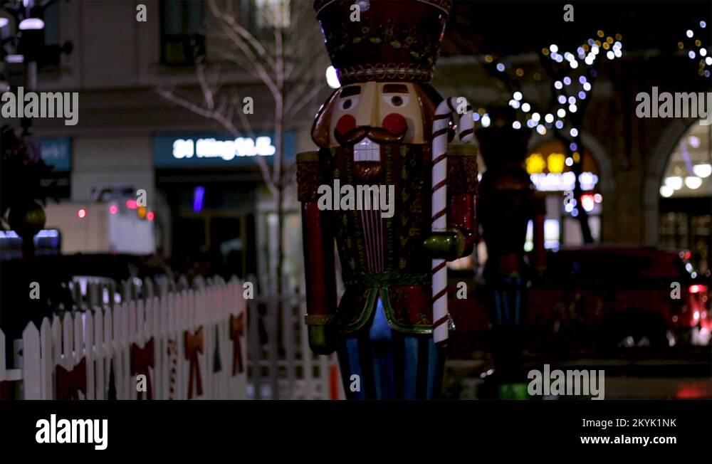 Large nutcracker holding a candy cane Christmas decoration display in