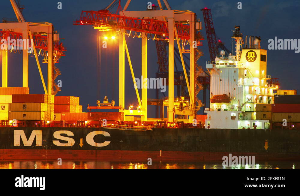 Unloading container cargo freight ship in container terminal in night ...