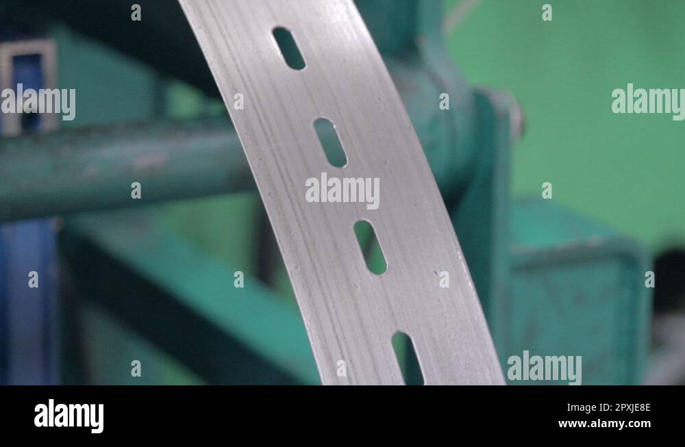 a machine bends perforated metal tape 2 Stock Video Footage Alamy