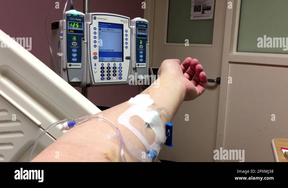 Close up patient with sodium drip needle lying on bed in hospital Stock