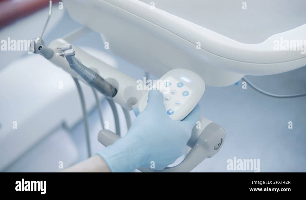 Closeup view of doctor s hand press the button on dentist chair, switches the Stock Video