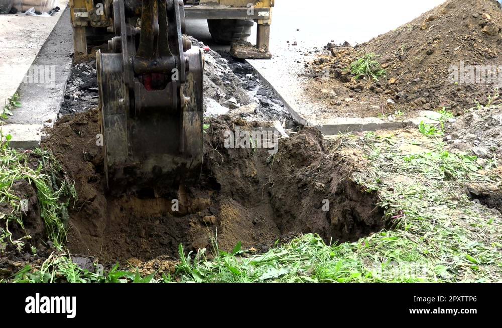 Tactor Diging Tractor bucket digging the ground during construction works Stock Video ...