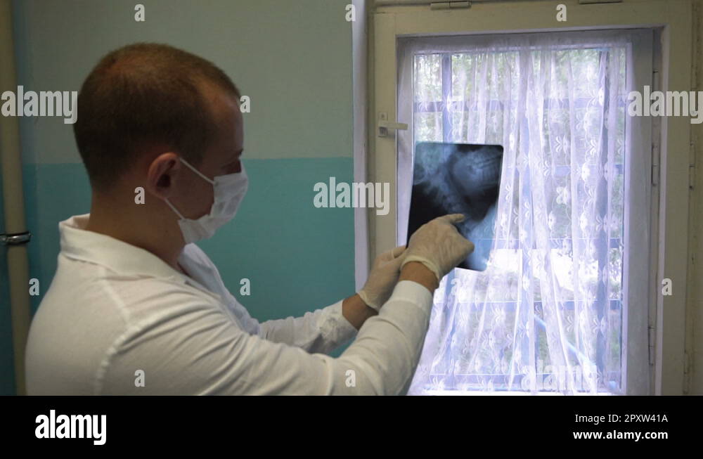 Doctor examining Xray searching diagnosis. Doctor hand pointing on x