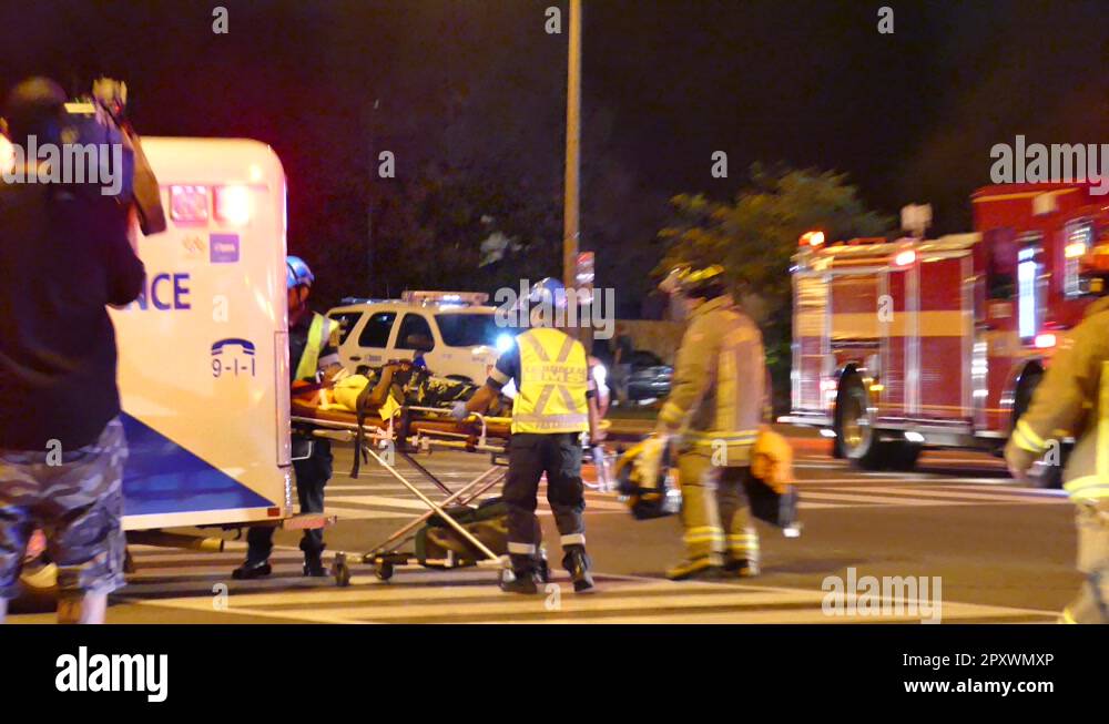 Paramedics and Firefighters transporting patient in a ambulance after ...