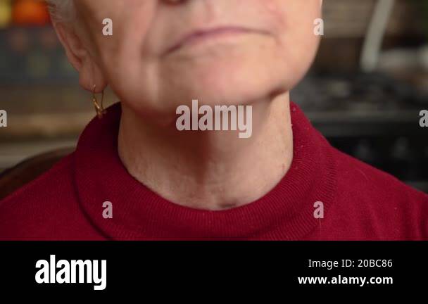 Close Up Elderly Woman Neck Old Female Swallows And Tenses Her Neck close-up-elderly-woman-neck-old-female-swallows-and-tenses-her-neck