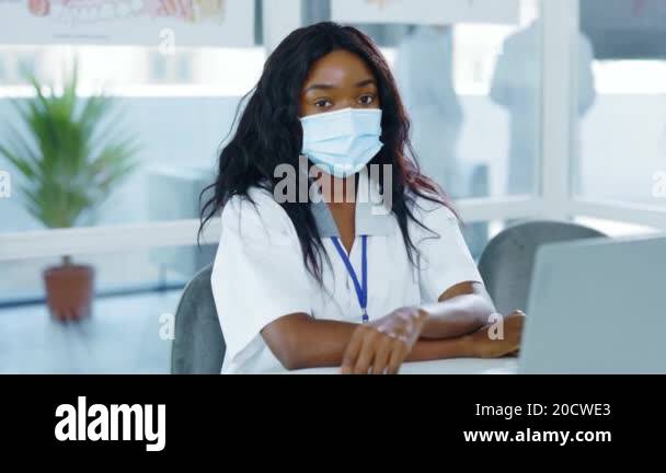 Young afro-american attractive female intern nurse wearing respiratory ...