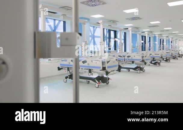 Modern hospital ward with rows of advanced medical beds, bright ...