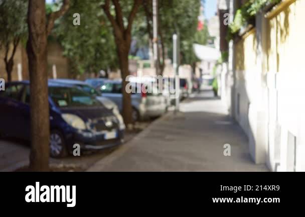 Blurred street scene in rome italy showcasing defocused cars trees and ...