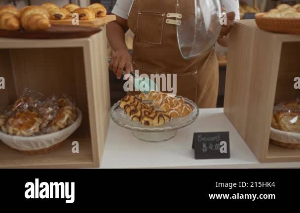 Woman baking pastries in bakery represents african american plus size ...
