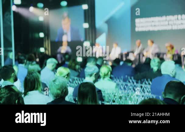 Corporate event with audience, panel discussions, and presentations ...
