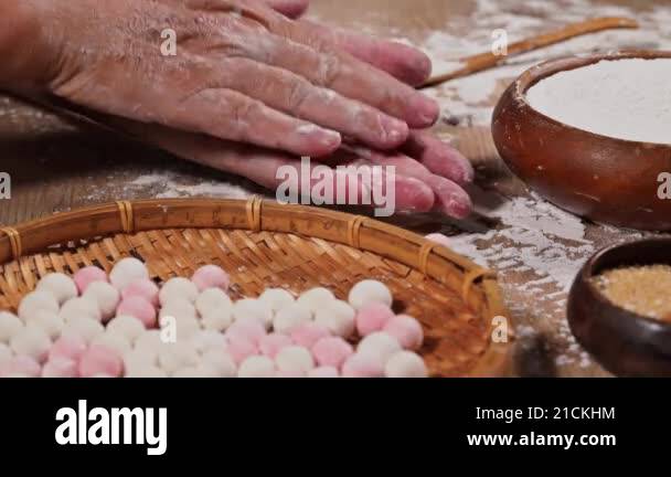 Making Tangyuan (Chinese sweet dumpling) . White and pink rice balls on ...
