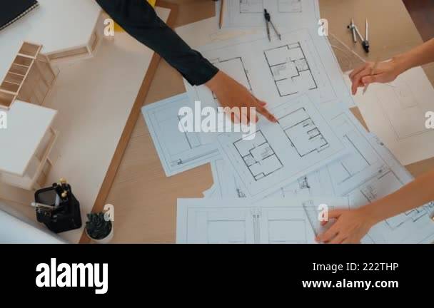Slow motion interior designer drafting blueprint with customer ...