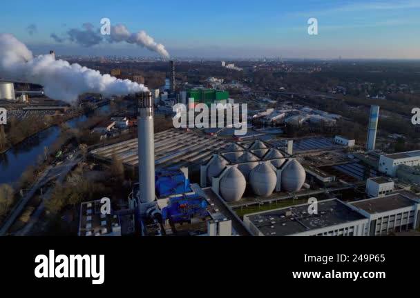 Aerial view of a waste to energy plant emitting smoke from its chimney ...