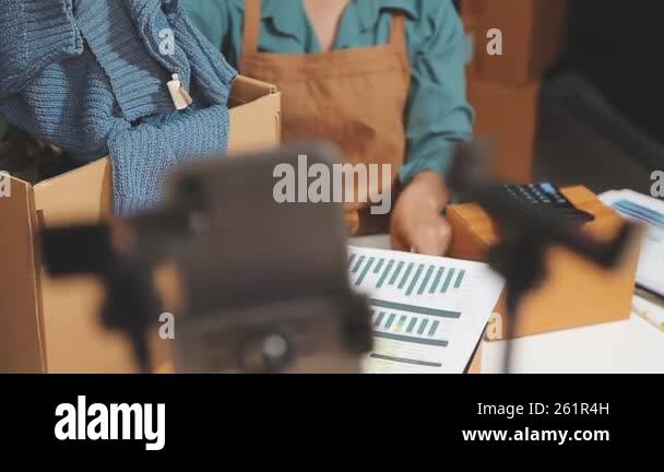 woman packing cardboard box with cardboard. delivery and shipping ...