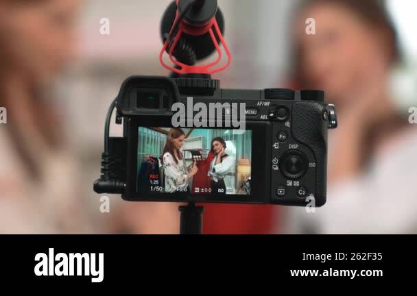 Rear view behide camera screen display two women influencer shoot vlog ...