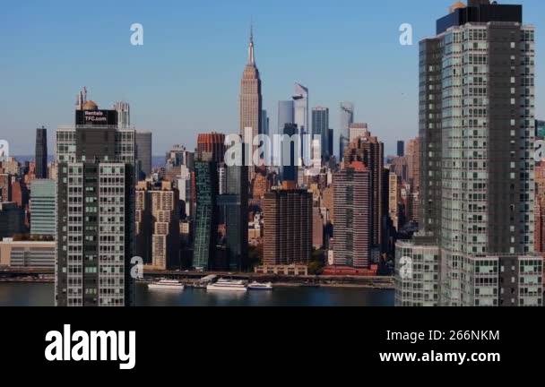 Camera sweeping over the East River from Queens reveals the iconic ...