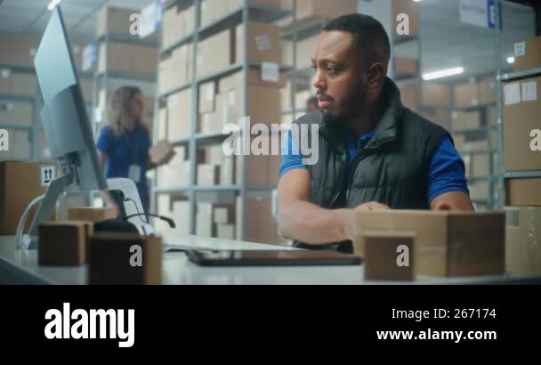 African American post office employee scans cardboard parcel using ...