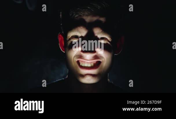Terrifying Expressions A young man makes eerie grimaces, flashes a terrifying smile, and plays ...