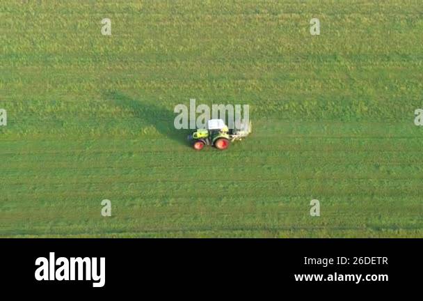 Tractor mowing lines in grass field Stock Video Footage - Alamy
