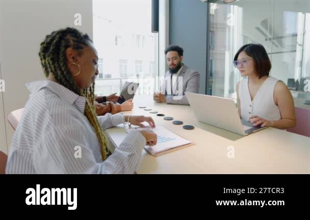 A skilled, diverse group of business professionals collaborates ...