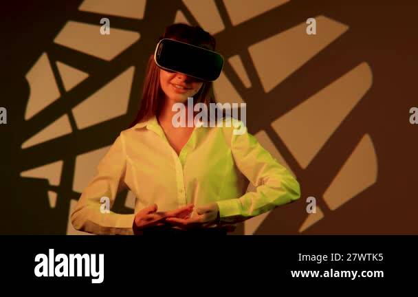 Woman engages with immersive technology while wearing virtual reality ...