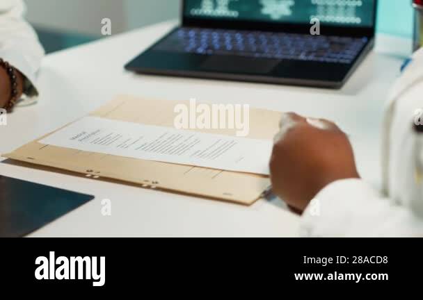 Physician signing the prescription paper to provide antibiotics to ...