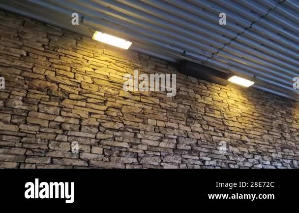 Modern gray brown, beige, metal door at the house lined with stone ...