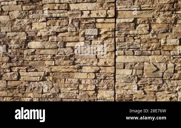 Modern gray brown, beige, metal door at the house lined with stone ...