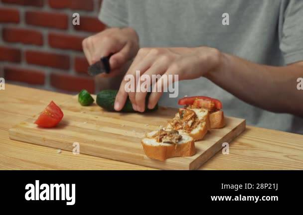 Home cooking daily routine. Man preparing lunch. Man sitting at table ...