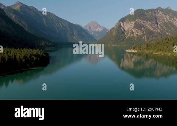 Start your day at the stunning Plansee Lake in Austria, where calm ...
