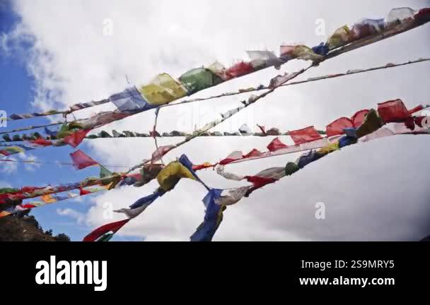 Captured in slow motion, colorful prayer flags move gracefully ...