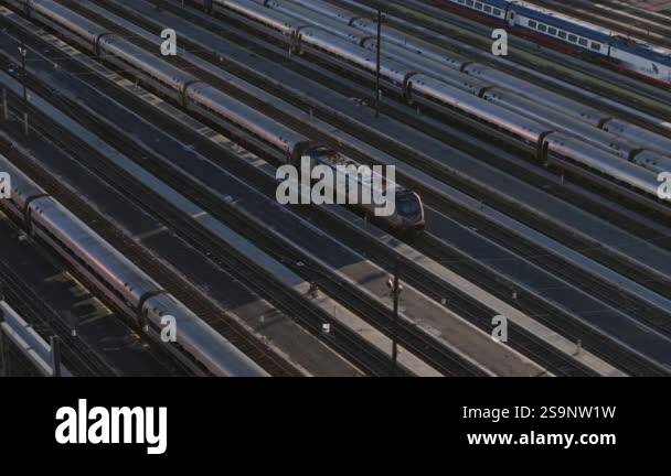 High angle aerial view capturing multiple passenger trains resting at ...